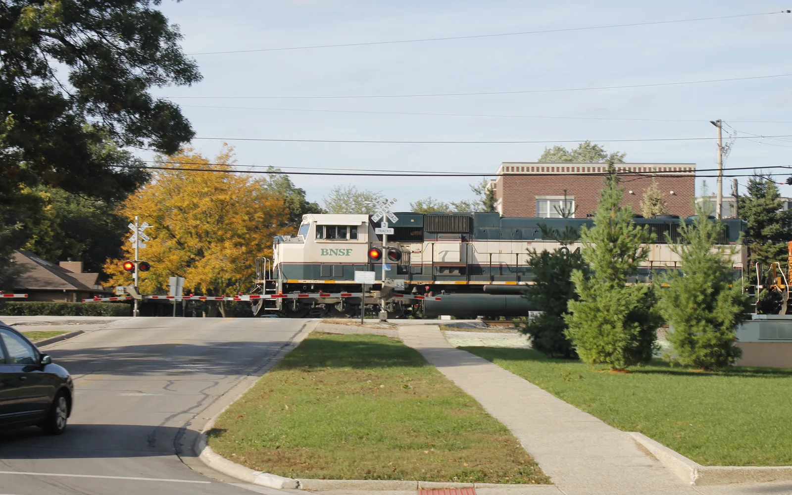 A BNSF diesel locomotive hauling a long freight train on railroad tracks, representing the logistics and transportation infrastructure of Southern California